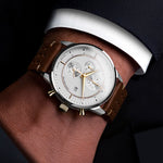 Luxury Matthew Mercury Chronograph watch with brown leather strap on a wrist against a dark background