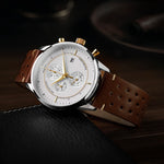 Luxury watch with brown leather strap on a dark background