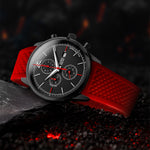 Wristwatch with red strap on a dark textured surface