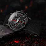 Black Chronograph watch with detailed face on a dark, textured surface with red accents