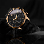 Luxury watch with black strap and gold accents on a dark background