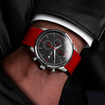 Man with leather jacket wearing a Matthew Mercury Chronograph Watch with a red strap, black dial, and red hands and details.