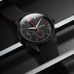 Black wristwatch with detailed face on a metallic background