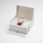 A white and red watch by Matthew Mercury displayed inside an open white presentation box with gold branding, set against a clean white background.